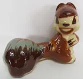 Ceramic squirrel figurine with a bushy tail.