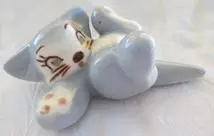 Blue and white porcelain figurine of a cat.