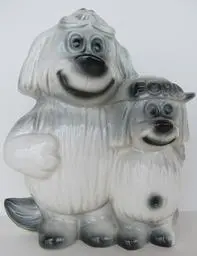 Two white ceramic dog figurines standing together.