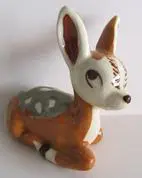 Ceramic figurine of a brown and white fawn.