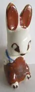 Ceramic bunny figurine with brown ears.