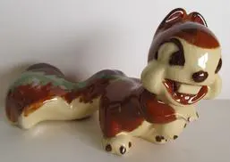 Ceramic squirrel figurine with brown and green glaze.