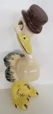 Ceramic figurine of a bird wearing a hat.