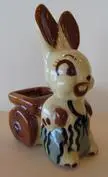 White ceramic rabbit pulling a brown wagon.