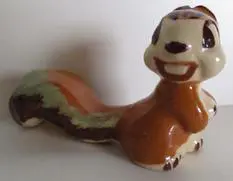 Ceramic squirrel figurine with brown and green glaze.