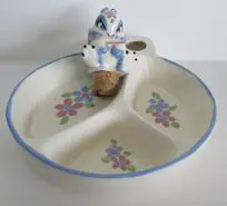 A divided dish with a bunny figurine.