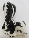 Black and white ceramic skunk figurine.