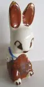 White ceramic rabbit figurine with brown ears.