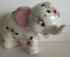 White ceramic elephant figurine with pink flowers.