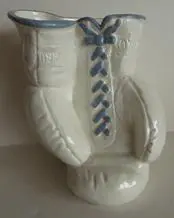 White ceramic boxing glove vase.