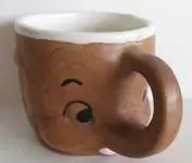 Brown ceramic mug shaped like an elephant.