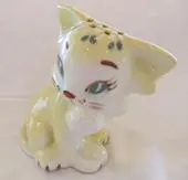 A porcelain figurine of a white cat.