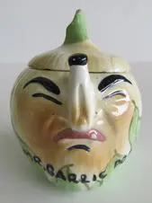 Ceramic onion-shaped garlic jar with a face.