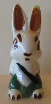 Ceramic rabbit figurine with green pants.