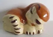 Ceramic figurine of a sleeping tiger.