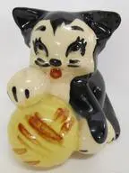 Black and white ceramic cat figurine with ball.