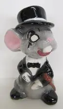 Ceramic figurine of a mouse in a tuxedo.