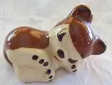 Ceramic figurine of a brown sleeping dog.