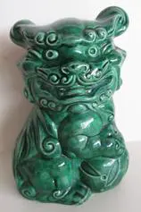 Green glazed ceramic foo dog statue.