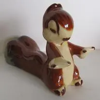 Brown and white ceramic squirrel figurine.