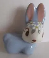 A blue ceramic bunny figurine with flowers.