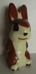 Ceramic bunny figurine with brown ears.