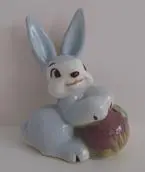 A blue ceramic rabbit holding a ball.