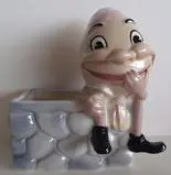 Ceramic Humpty Dumpty planter with a wall.