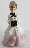 Porcelain figurine of a woman in a dress.