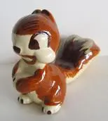 Ceramic squirrel figurine with brown and white glaze.