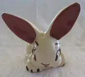 White ceramic bunny with brown ears.