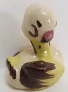 Ceramic duck figurine with brown and yellow paint.