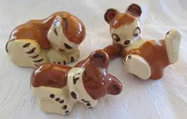 Three ceramic figurines of brown animals.