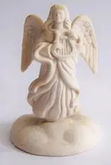 White porcelain angel figurine playing a harp.