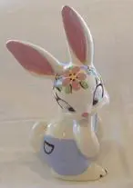 White porcelain rabbit figurine with floral details.