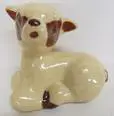 Ceramic figurine of a brown and white lamb.