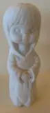 White porcelain figurine of a girl.