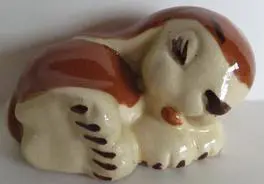 Ceramic figurine of a sleeping dog.