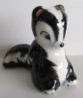 Black and white ceramic skunk figurine.