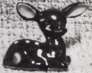 Black and white figurine of a fawn.