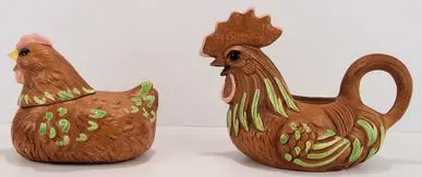 Ceramic hen and rooster figurines.