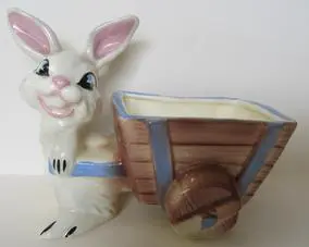 White bunny pulling a brown wagon planter.