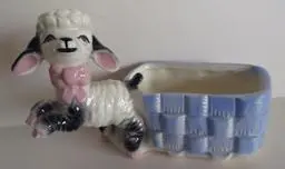 Ceramic lamb planter with blue basket.