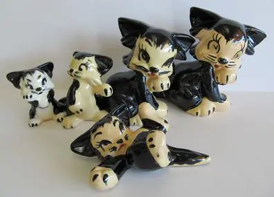 Ceramic black and white cat figurines.