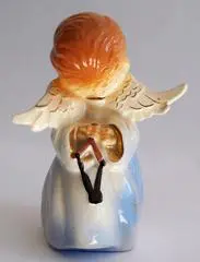 Ceramic angel figurine with wings and a harp.