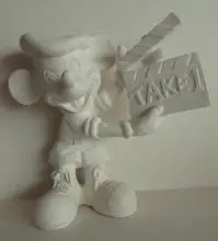 A white ceramic figurine of Mickey Mouse.