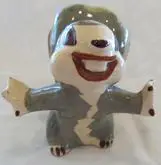 Ceramic figurine of a smiling cartoon animal.