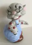 Ceramic figurine of a cat wearing glasses.