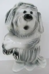 Ceramic dog piggy bank with a scarf.