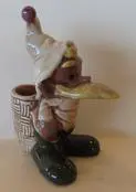 Ceramic figurine of a bird wearing a hat.